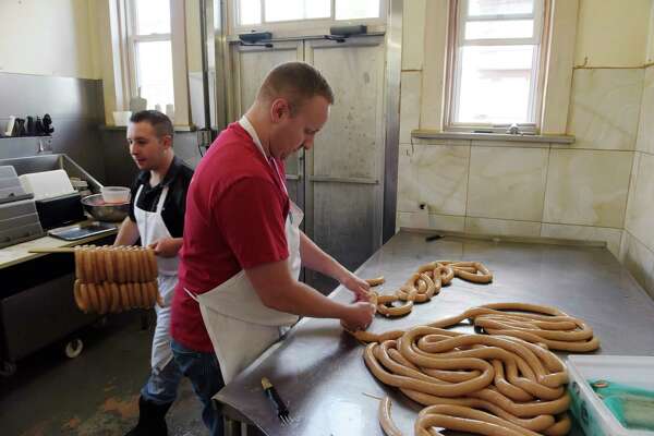 AJ Indovina, left, and Bob Eggelhoefer make hot dogs at RolfÕs Pork Store on Wednesday, May 23, 2018, in Albany, N.Y.   (Paul Buckowski/Times Union)