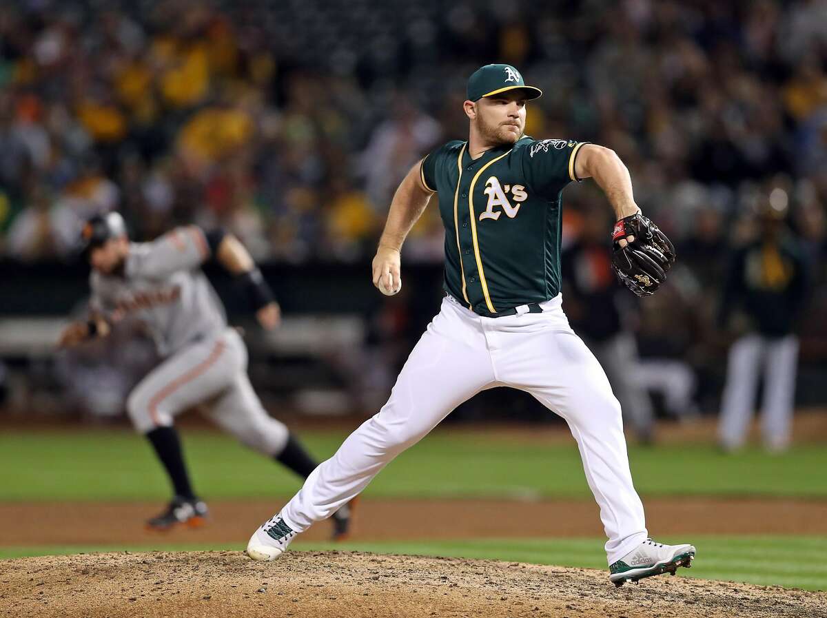 Oakland Athletics' Liam Hendriks pitches against San Francisco Giants in 7th inning during MLB game at Oakland Coliseum in Oakland, Calif. on Monday, July 31, 2017.