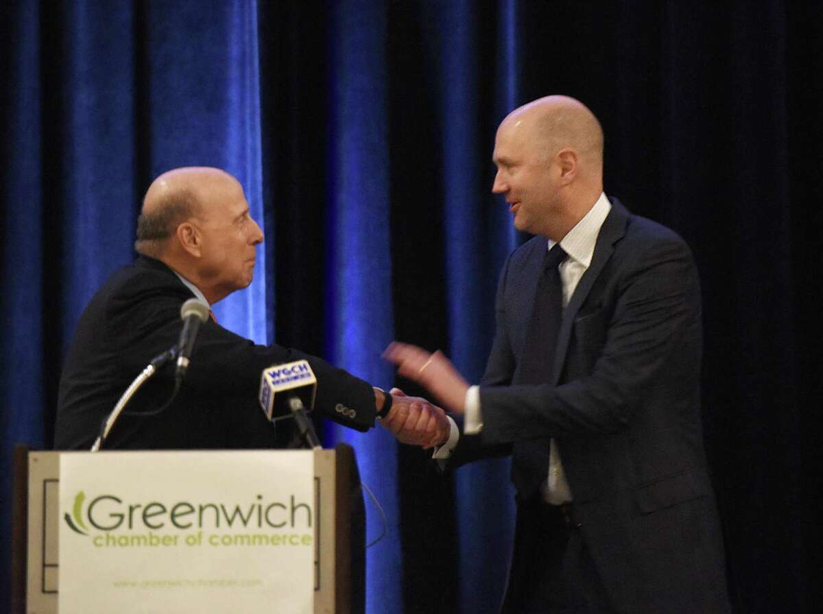 Richards owner Scott Mitchell accepts his award in corporate leadership from last year’s winner, Richard Koppelman, of Miller Motorcars, at the 2018 Greenwich Chamber of Commerce Awards Luncheon at the Hyatt Regency in Greenwich on Thursday.