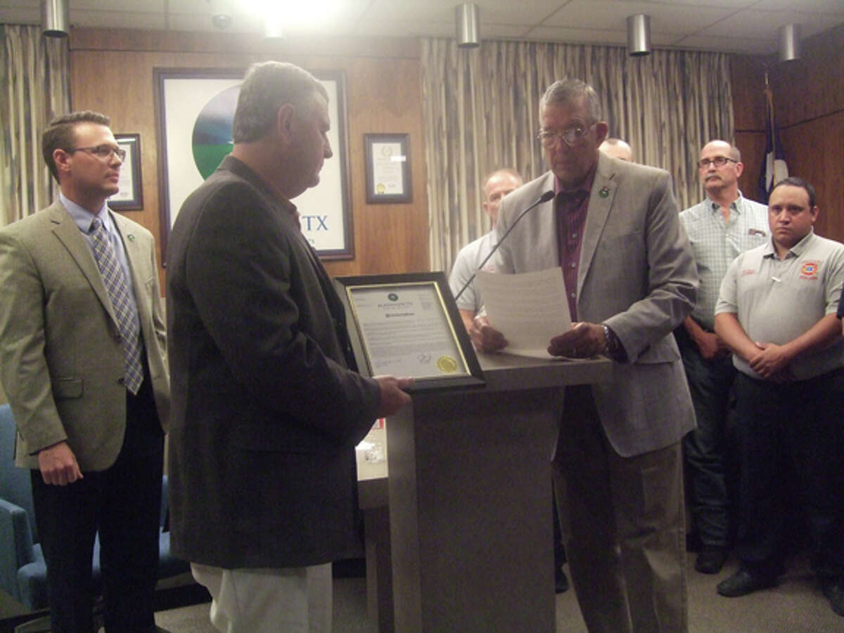 Plainview Mayor Wendell Dunlap reads a proclamation honoring Plainview Fire Chief Rusty Powers as the retiring longtime employee holds a framed copy during Tuesday’s Plainview City Council Meeting. Powers will officially step down on June 1 after 28 years with the Plainview Fire Department. He’s been chief for the past nine years.