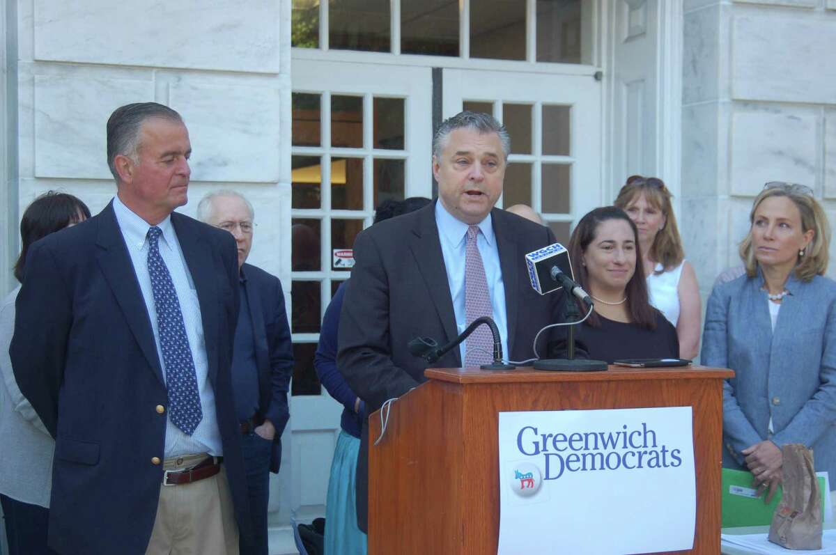 Democratic Town Committee Chair Tony Turner, behind podium, speaks on behalf of party candidates for the General Assembly, from left: Stephen Meskers, Laura Kostin and Alexandra Bergstein, Thursday morning at Town Hall.