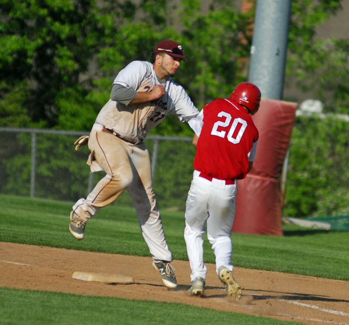 Bethel’s Jaxon Millet, left, tags a Masuk runner during their SWC semifinal game on Thursday.