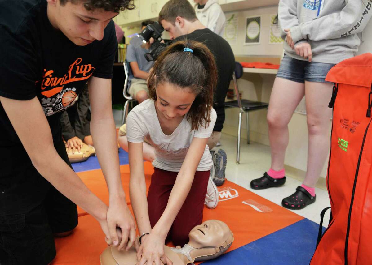 Catskill High School senior Yusef Abushqier teaches hands-only CPR to Catskill Middle School student Isis Gonzalez May 11 at Catskill High School, using American Heart Association hands-only CPR equipment donated to the Catskill school district by Columbia Memorial Health. 395,000 people suffer sudden cardiac arrest each year. Having CPR performed doubles or triples the chances of survival of those suffering a cardiac arrest. The American Heart Association says it led the campaign to pass the CPR in Schools law, which requires that every graduate of a New York high school learn hands-only CPR. Columbia Memorial?s donation of the CPR in Schools kit will make it easier for Catskill to comply with the law.