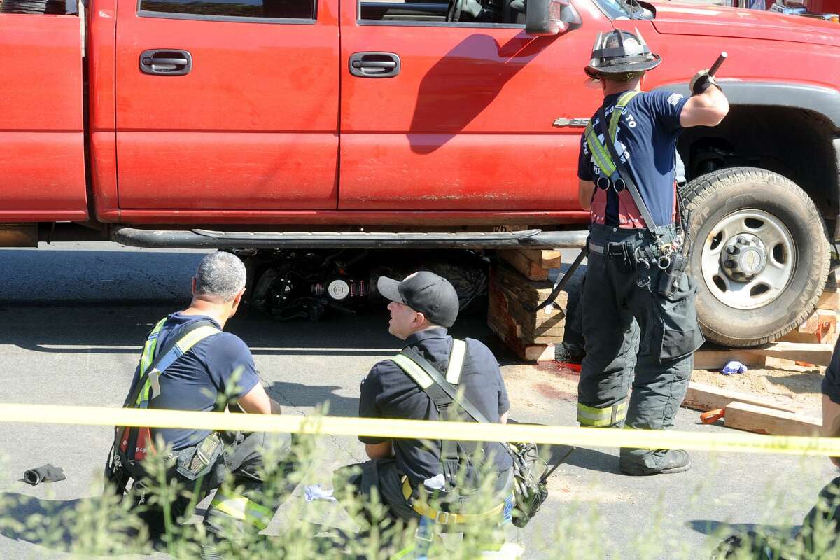 Firefighters free person trapped under truck