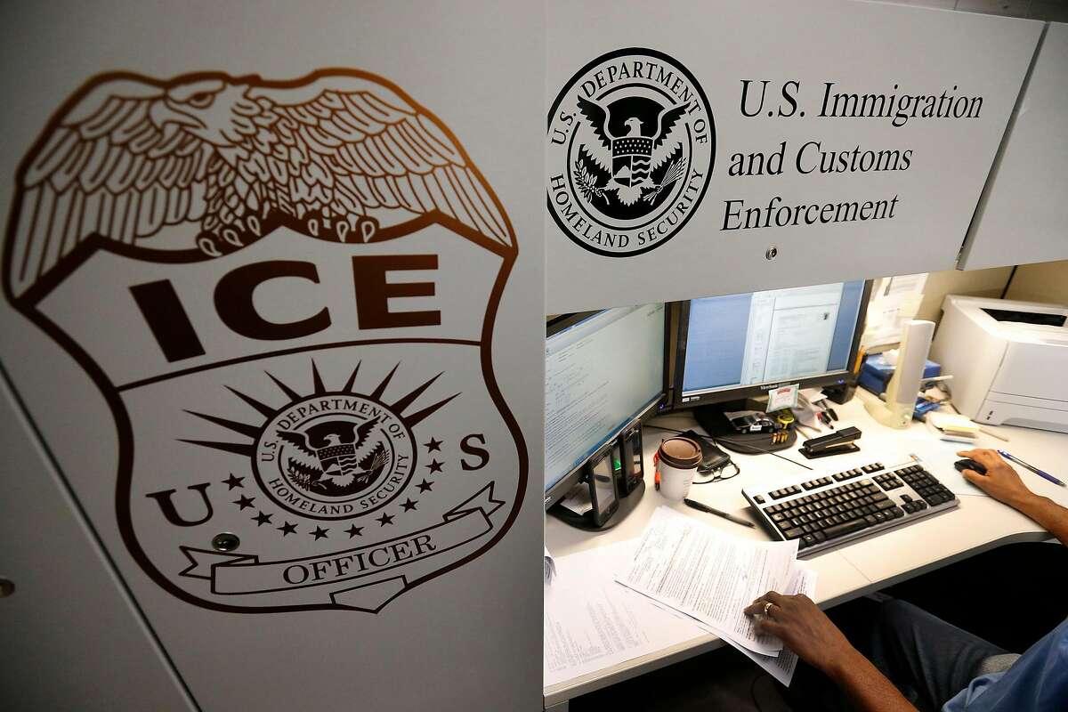 An unidentified Immigration and Customs Enforcement deportation officer reviews forms required to issue a detainer asking local law enforcement to hold someone until ICE agents can pick the person up, on Wednesday, April 26, 2017 at the the Pacific Enforcement Response Center in Laguna Niguel, Calif. (Allen J. Schaben/Los Angeles Times/TNS)