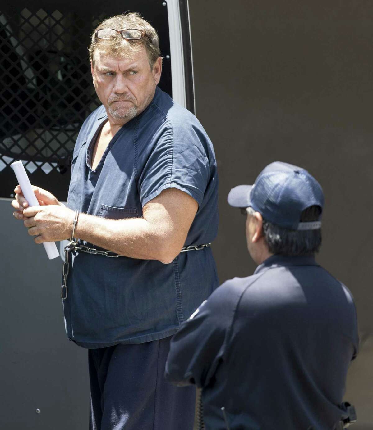 Robert Ussery, is escorted Thursday, May 24, 2018 out of the federal courthouse after appearing before U.S. Magistrate Judge Henry Bemporad. He faces a federal charge with approaching Sutherland Springs pastor Frank Pomeroy on March 5 and telling him that his daughter, slain in the November massacre, never existed.