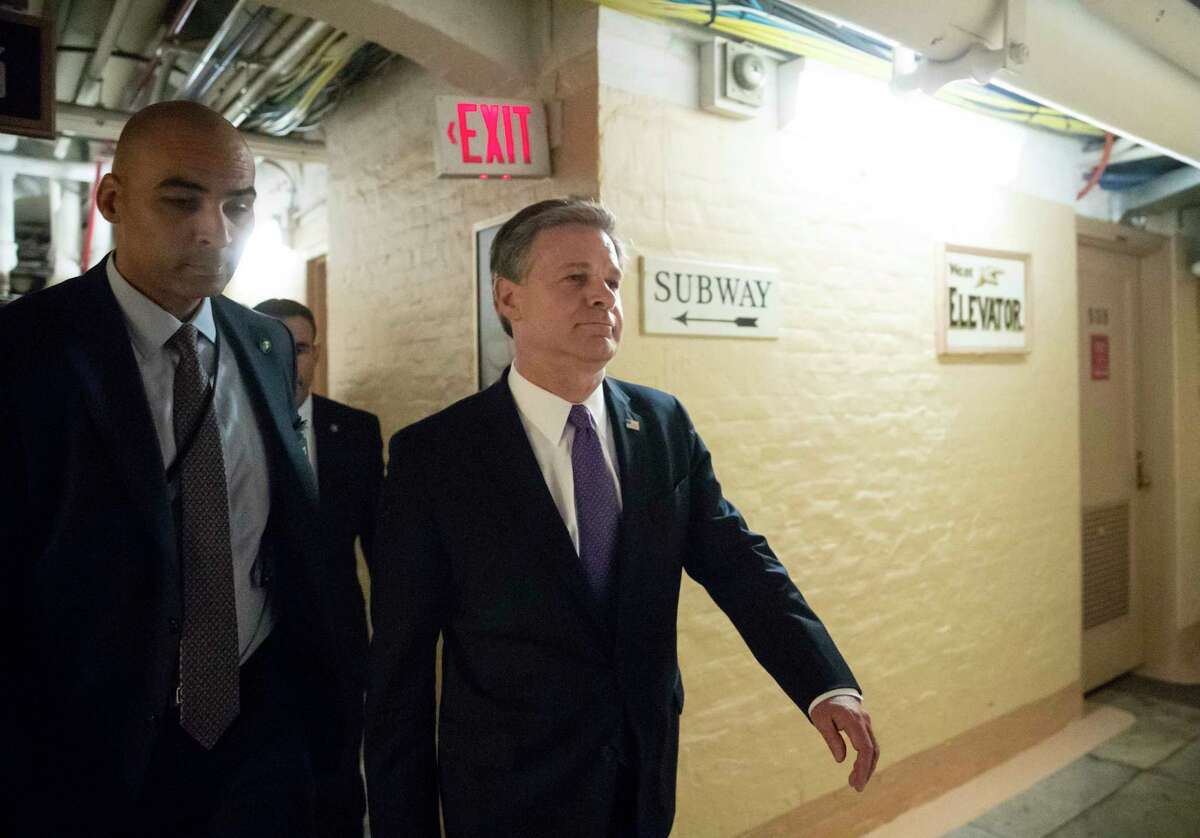 FBI Director Christopher Wray departs the Capitol through a basement corridor after House and Senate lawmakers from both parties met for a classified briefing about the federal investigation into President Donald Trump's 2016 campaign, on Capitol Hill in Washington, Thursday, May 24, 2018. (AP Photo/J. Scott Applewhite)