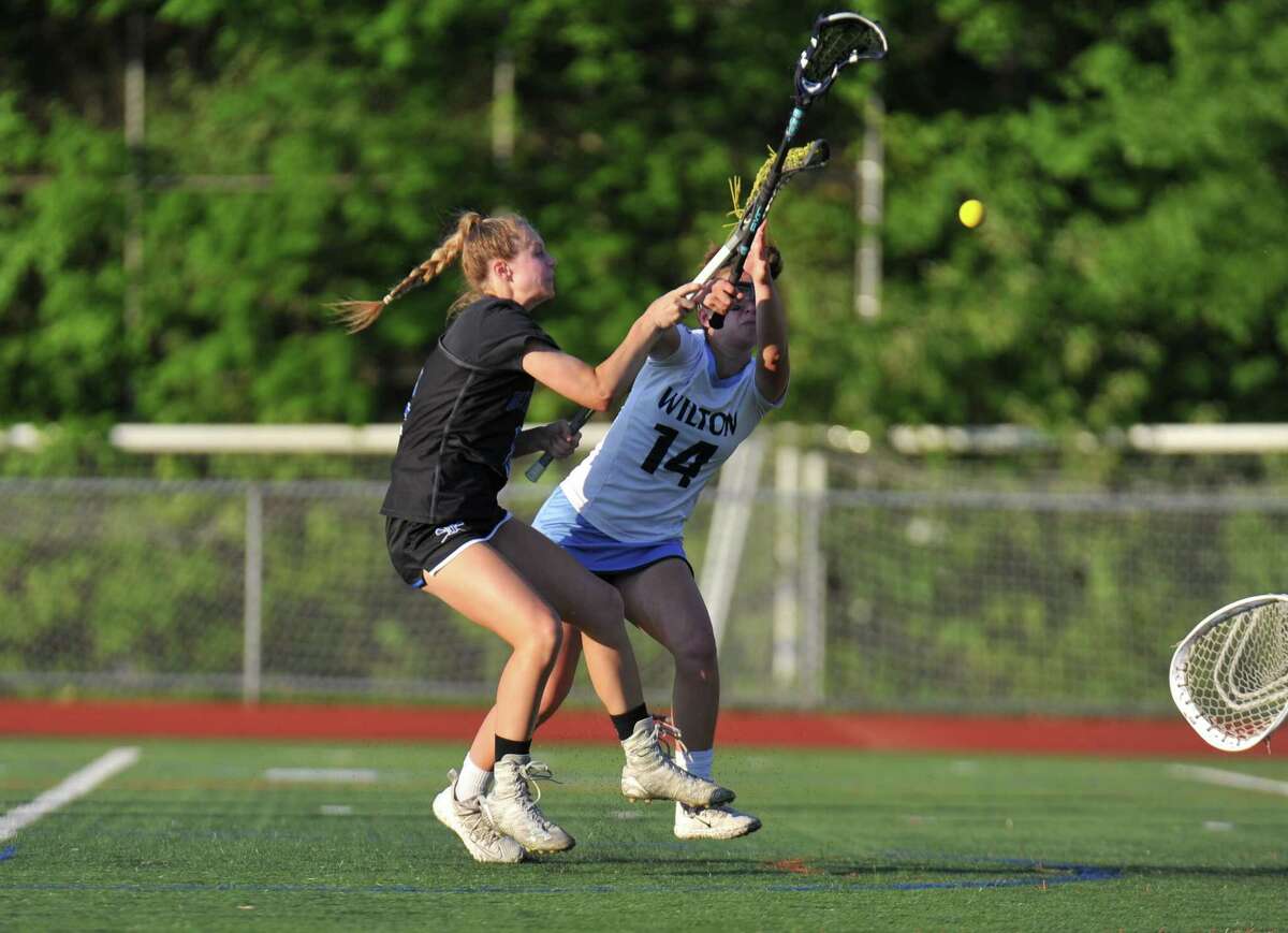 Darien’s Emma Jaques shoots and scores during the FCIAC championship game against Wilton on Thursday.