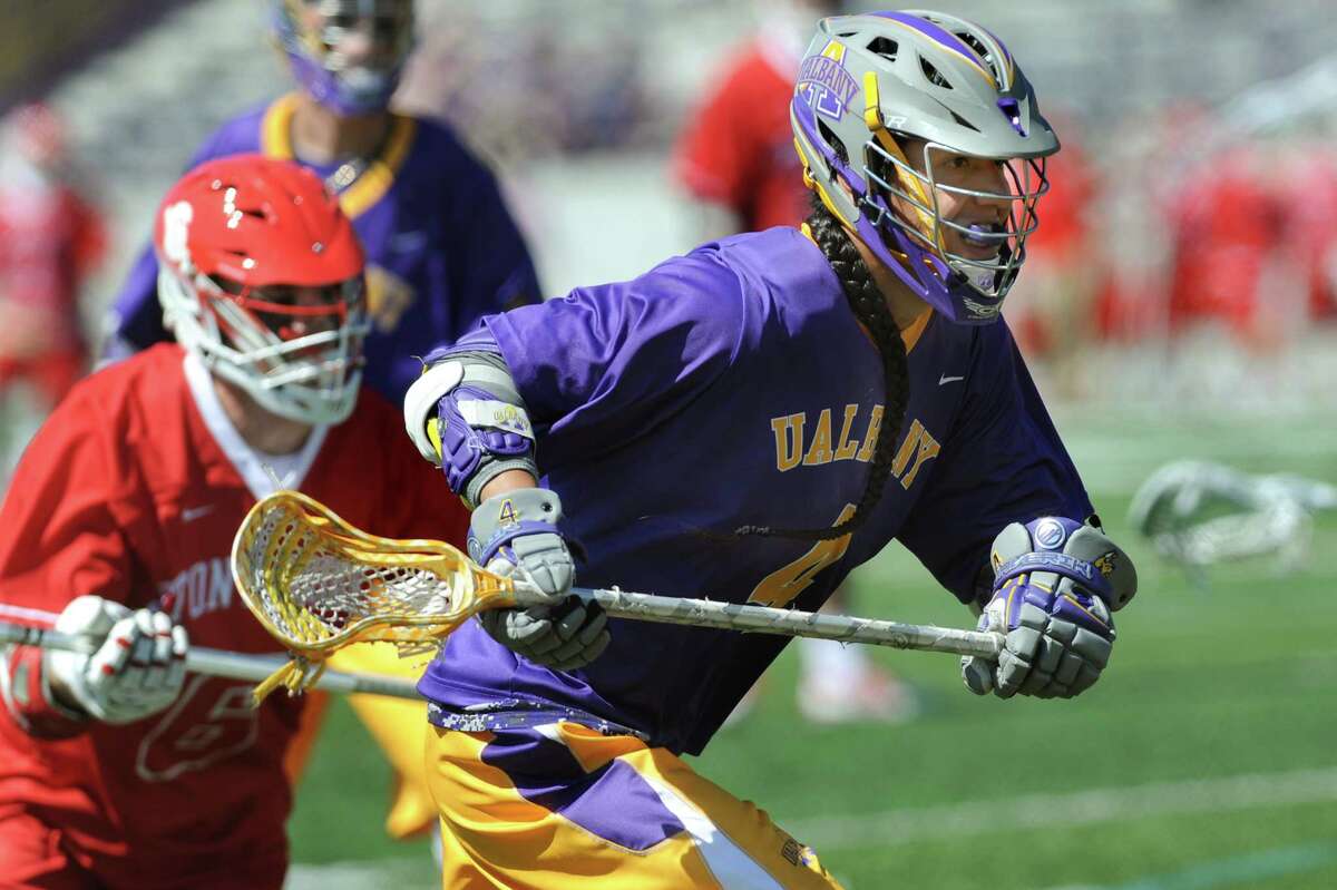 UAlbany's Lyle Thompson, right, chases a ball during the America East Conference championship lacrosse game against Stony Brook in 2015. Thompson said he's going to enjoy looking around the campus at UAlbany, which he hasn't been back to since he graduated.