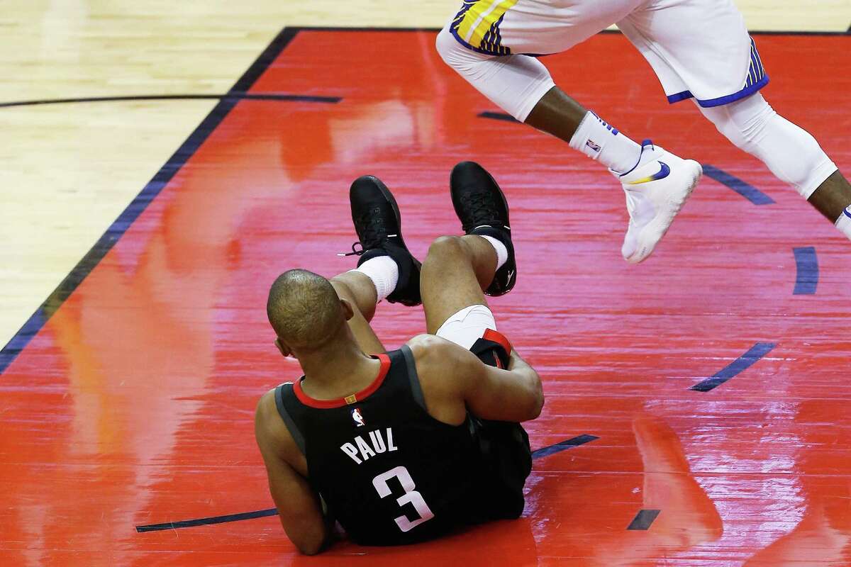 HOUSTON, TX - MAY 24: Chris Paul #3 of the Houston Rockets grabs his leg after falling against the Golden State Warriors in the fourth quarter of Game Five of the Western Conference Finals of the 2018 NBA Playoffs at Toyota Center on May 24, 2018 in Houston, Texas.