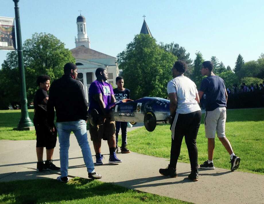 Teens take part in a soapbox derby through the Schenectady school district's My Brother's Keeper program on the Union College campus on Thursday, May 24, in Schenectady, N.Y. The youngsters, mostly African-American, say constructing the cars taught them about match and science and the importance of team work. (Paul Nelson/Times Union) Photo: Albany Times Union