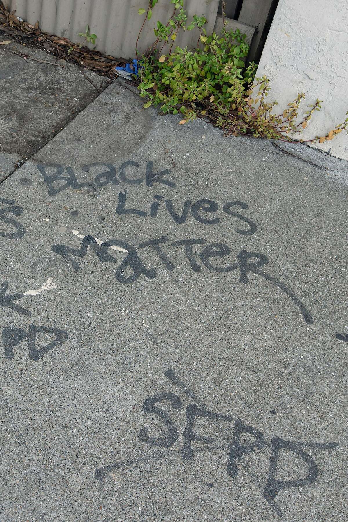 Graffiti marks the spot in San Francisco’s Bayview neighborhood where police fatally shot stabbing suspect Mario Woods.