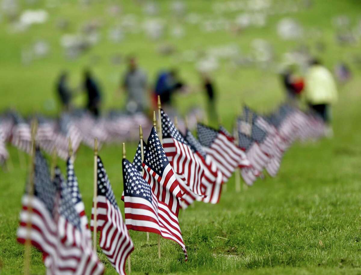 Flags on the graves of veterans at the Allegheny Cemetery in Pittsburgh, Wednesday for the upcoming Memorial Day holiday weekend.