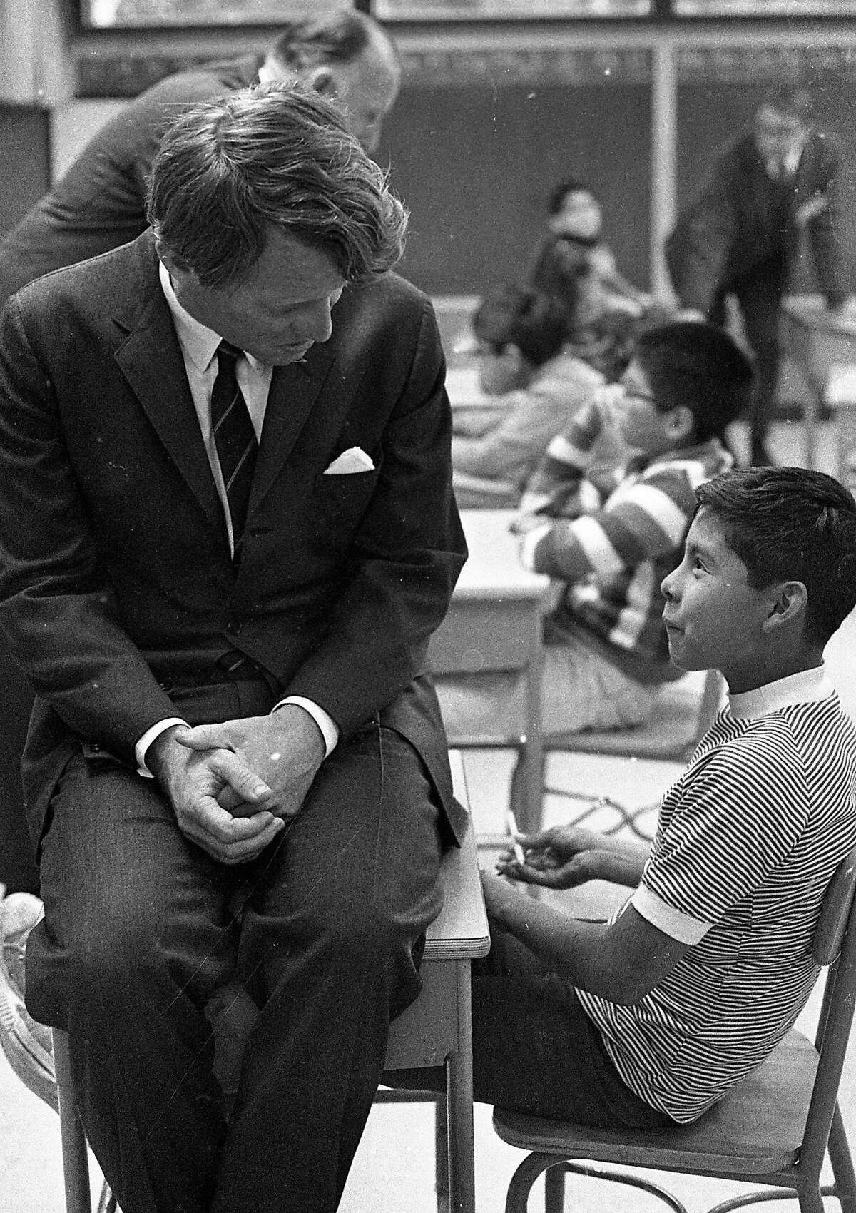 Senator Robert F. Kennedy talks to a student in school at the Kashia Indian Reservation about 100 miles north of San Francisco February 3,1968