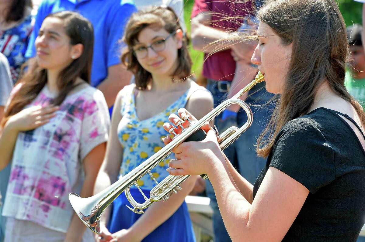 Student Olivia Achcet play taps during a wreath laying ceremony to honor lives of 3 Nisky HS graduates who were killed in Vietnam war at Niskyauna High School Friday May 25, 2018 in Niskayuna, NY. (John Carl D'Annibale/Times Union)