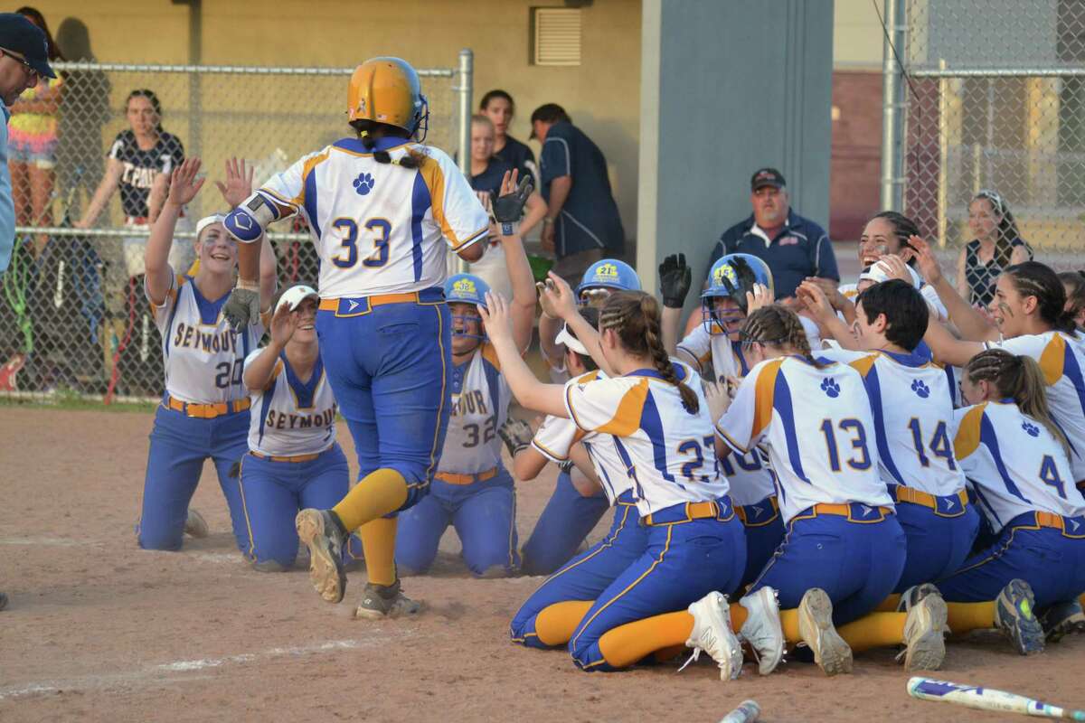 Seymour’s Chelsea Avila is greeted at home plate by her teammates after hitting a home run in Seymour’s win over St. Paul in the NVL championship game on Friday.