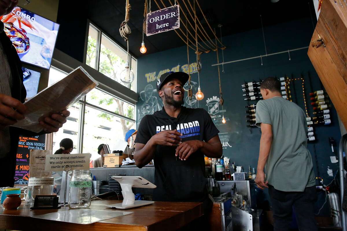 Antonio Johnson takes orders from patrons at alaMAR Kitchen in Oakland, Ca., as seen on Thurs. May 24, 2018.