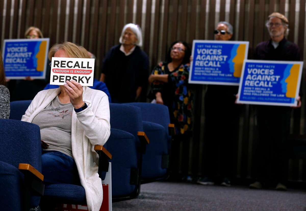 Recall supporter Belinda Stow and opponents of the effort (background) attends a meeting of the Santa Clara County Board of Supervisors, who were expected to approve a ballot measure to recall Judge Aaron Persky in San Jose, Calif. on Tuesday, Feb. 6, 2018. Persky came under fire for handing down a six-month sentence to former Stanford athlete Brock Turner after a conviction on sexual assault.