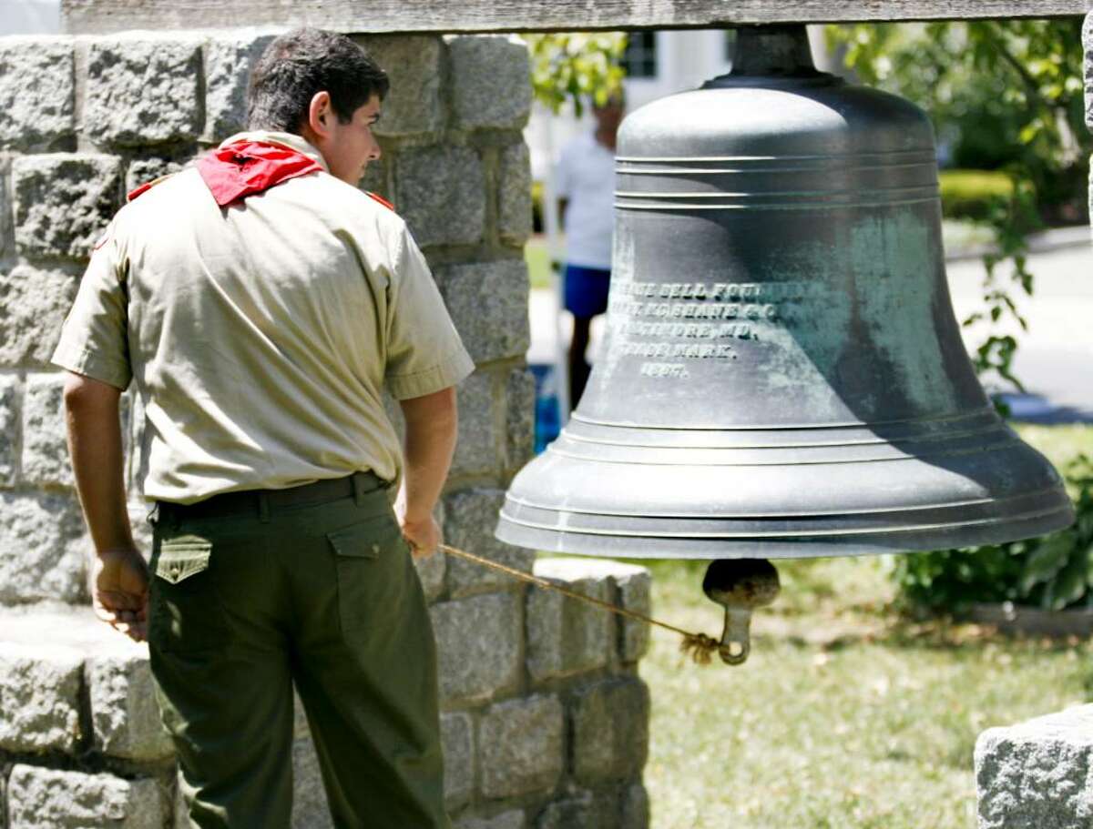 Adam Schwabacher of the Boy Scout troop 721 rings the bell on the Milford Green on Sunday, July 4, 2010 during a ceremony honoring the signing of the Declaration of Independence.