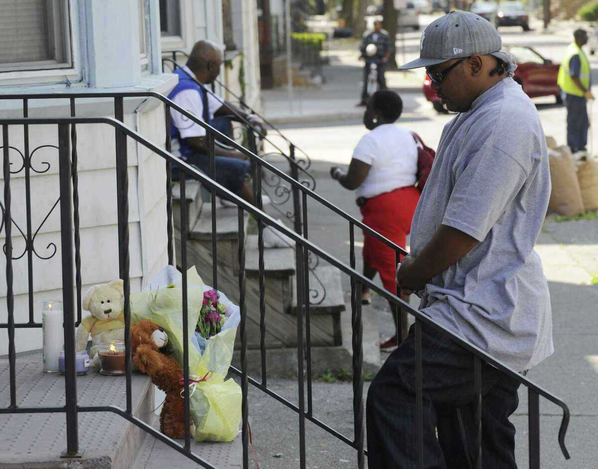 Times Union staff photo by Skip Dickstein - Shawn Clark of Albany says a quiet prayer at the scene of the death of 10-year-old Kathina Thomas, at 445 First St. in Albany, New York May 30, 2008.
