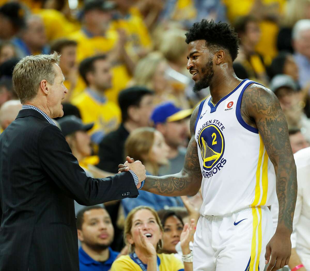 Golden State Warriors' head coach Steve Kerr congratulates Jordan Bell in the fourth quarter during game 6 of the Western Conference Finals between the Golden State Warriors and the Houston Rockets at Oracle Arena on Saturday, May 26, 2018 in Oakland, Calif.