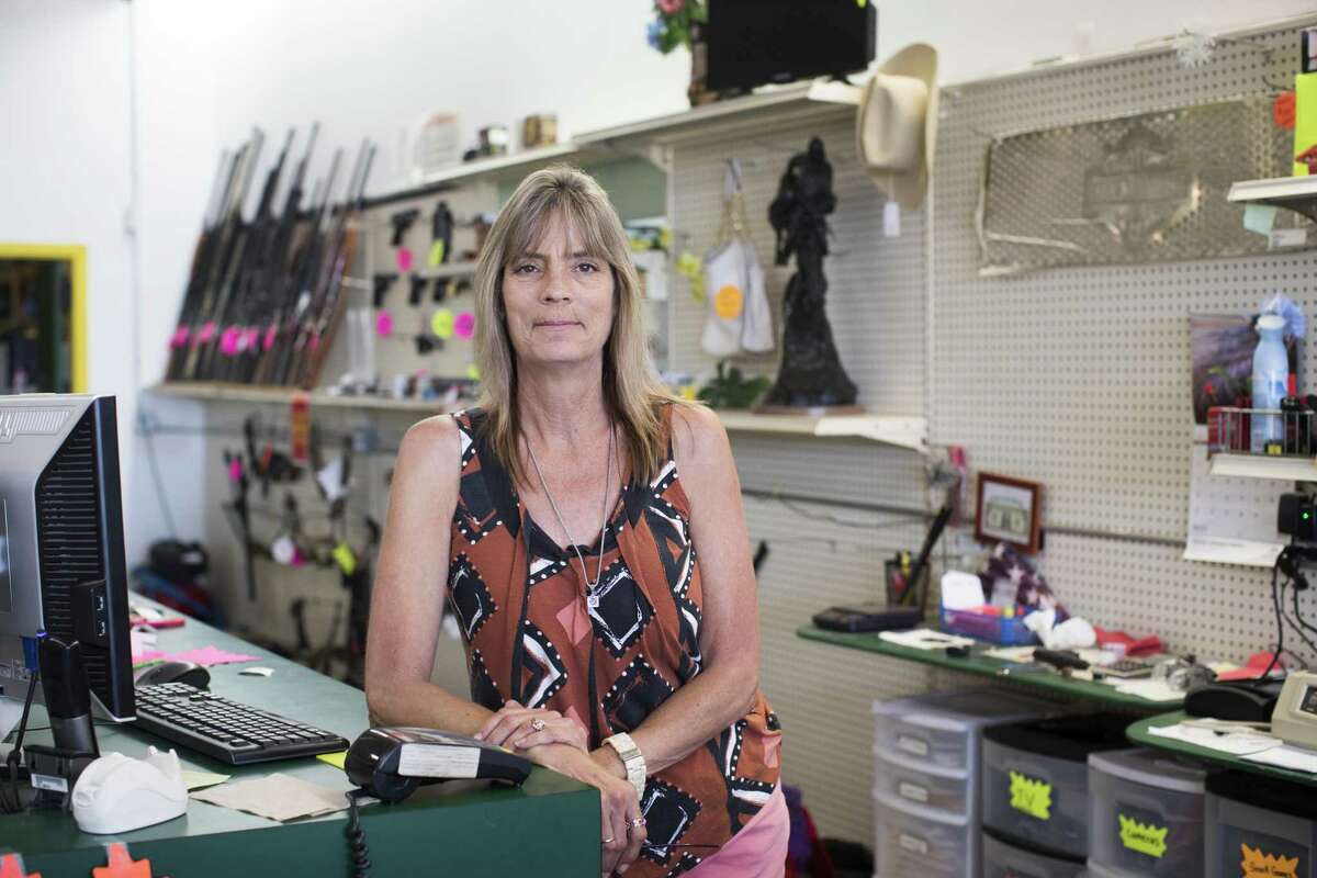 Pawn broker and gun owner Cheryl Darling, shown here on May 22, 2018, grew up with guns and was taught how to use them very young. She said they are very much part of the local culture in Santa Fe in Galveston County.