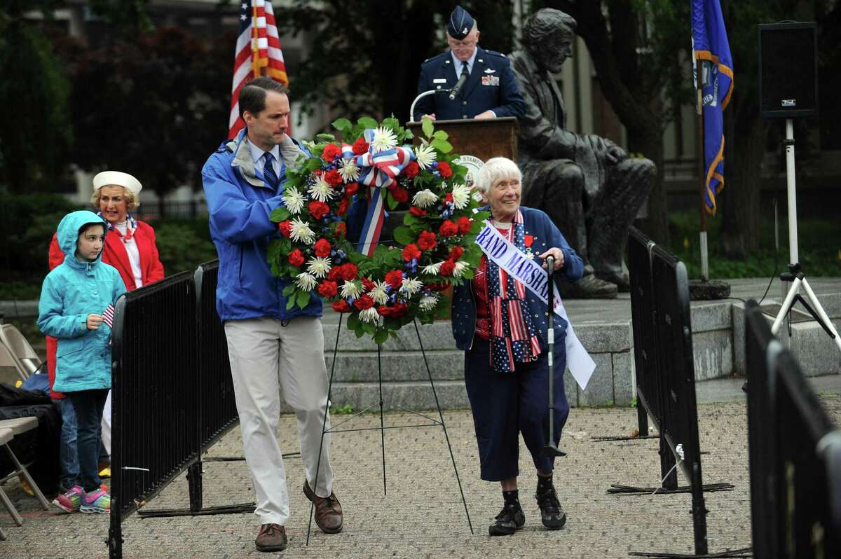 Congressman Jim Himes (D- Conn.), left, and parade grand marshal First Lieutenant Lillian R. Catananello Walla walk with the honorary wreath during the ceremony at Veteran's Park following Stamford's annual Memorial Day parade in downtown Stamford, Conn. on Sunday, May 27, 2018.