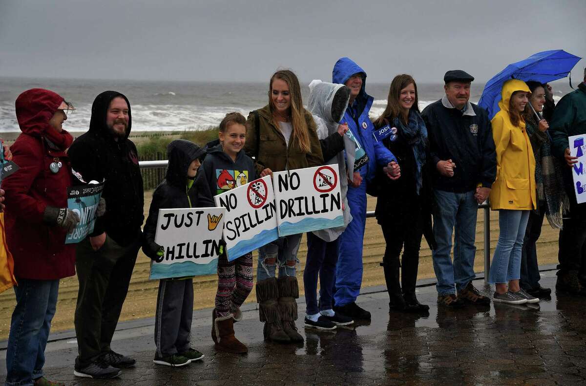 Members of several environmental groups, along with local and state politicians, join a "Hands Across the Sand" event in Bradley Beach, N.J., showing their opposition to offshore drilling and support of a clean-energy economy.