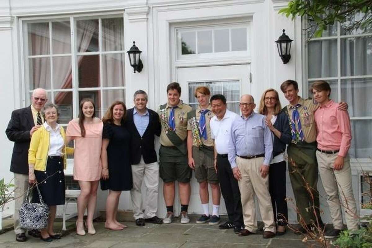New Eagle Scouts Leo Johnson (center, left) and Will Graney Green (center, right) are joined by Sen. Tony Hwang (fifth from right) and their parents, grandparents, and siblings in celebrating their Court of Honor.