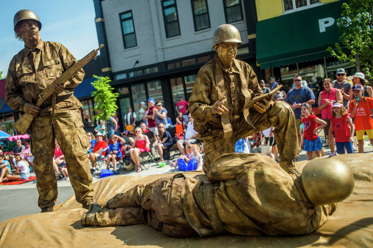 The St. Timothy Lutheran Church float features men in costume posing as a statue during the annual Memorial Day Parade in downtown Midland. (Katy Kildee/kkildee@mdn.net)