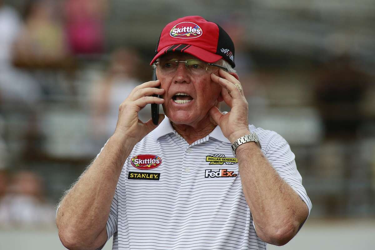 Car owner Joe Gibbs talks on the phone after his car won the NASCAR Brickyard 400 auto race at Indianapolis Motor Speedway in Indianapolis, Sunday, July 26, 2015. (AP Photo/R Brent Smith)