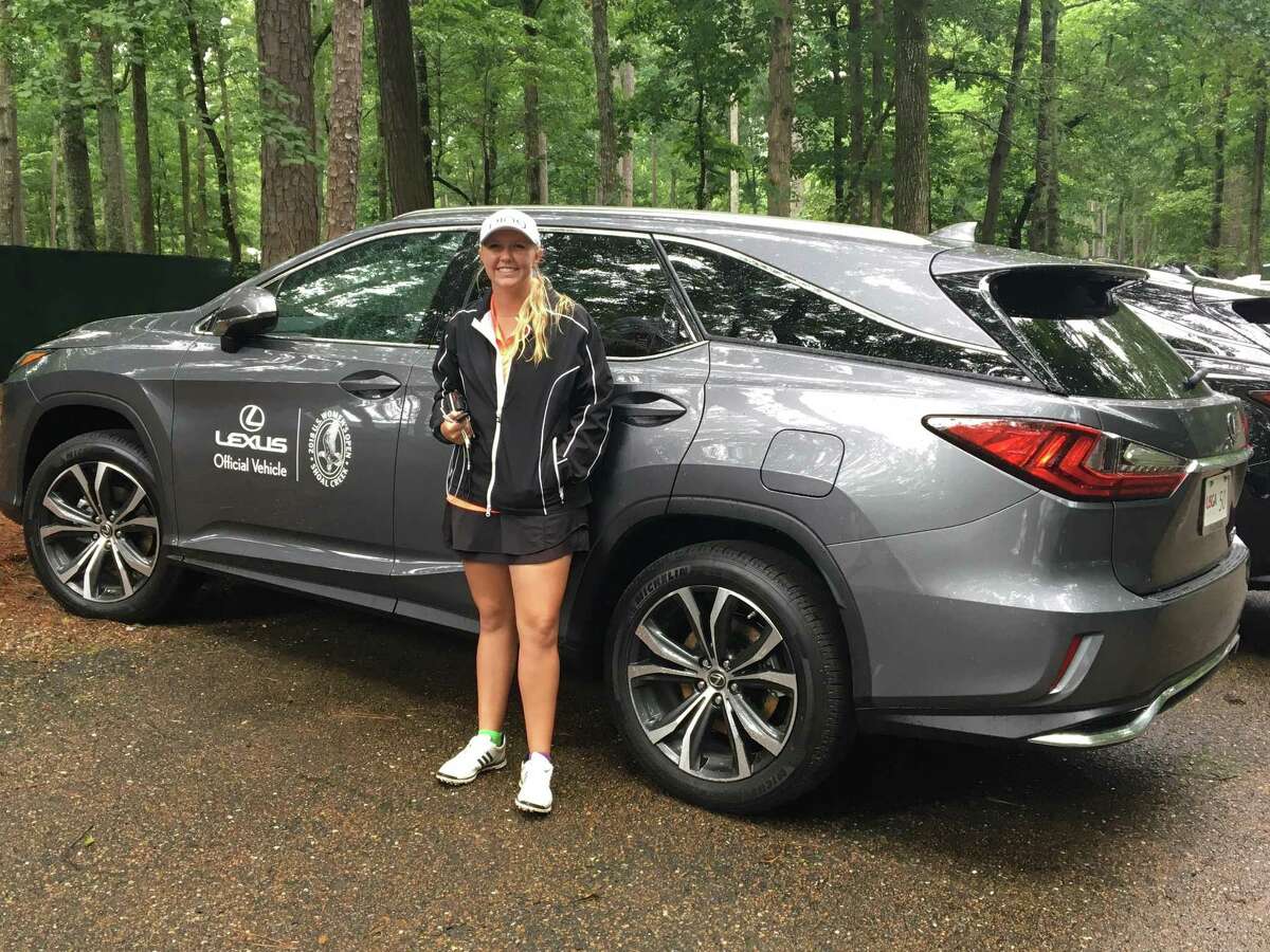 Montgomery's Hailee Cooper poses with her Lexus courtesy car at the 2018 U.S. Open golf tournament in Hoover, Alabama on Monday.