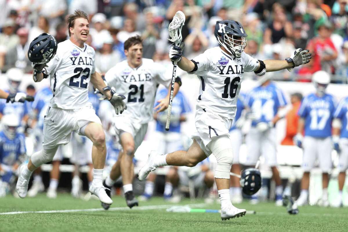 FOXBORO, MA - MAY 28: Ryan McQuaide #22 of the Yale Bulldogs, Conor Mackie #21 and William Renz #16 celebrate after defeating the Duke Blue Devils 13-11 in the 2018 NCAA Division I Men's Lacrosse Championship game at Gillette Stadium on May 28, 2018 in Boston, Massachusetts. (Photo by Maddie Meyer/Getty Images)