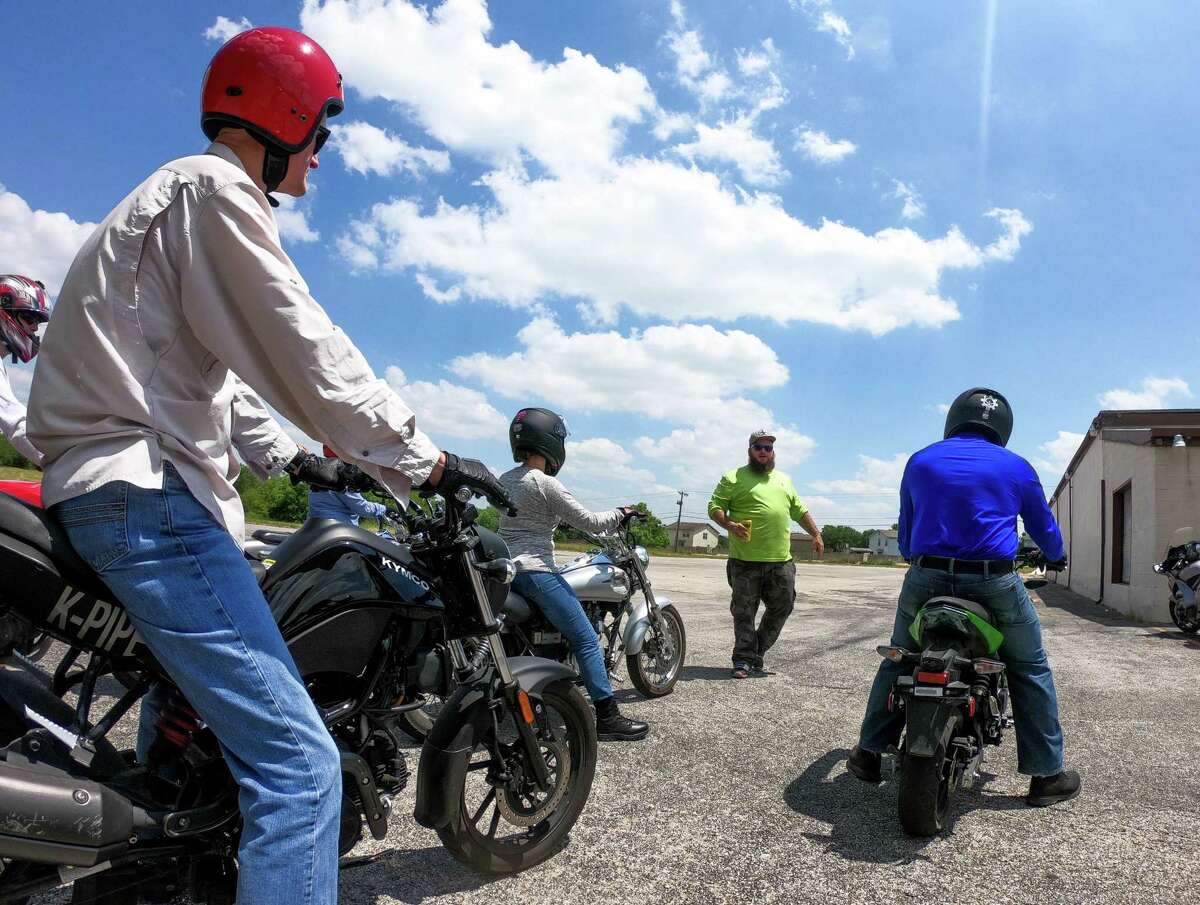 Ian Munce (back), of Southwest Motorcycle Training, works with novice riders during National Motorcycle Safety Awareness Month. Munce taught them how to properly mount a motorcycle, how to control speed using the clutch, and other important things. Munce is the brother of the school’s owner, Marshall Munce.