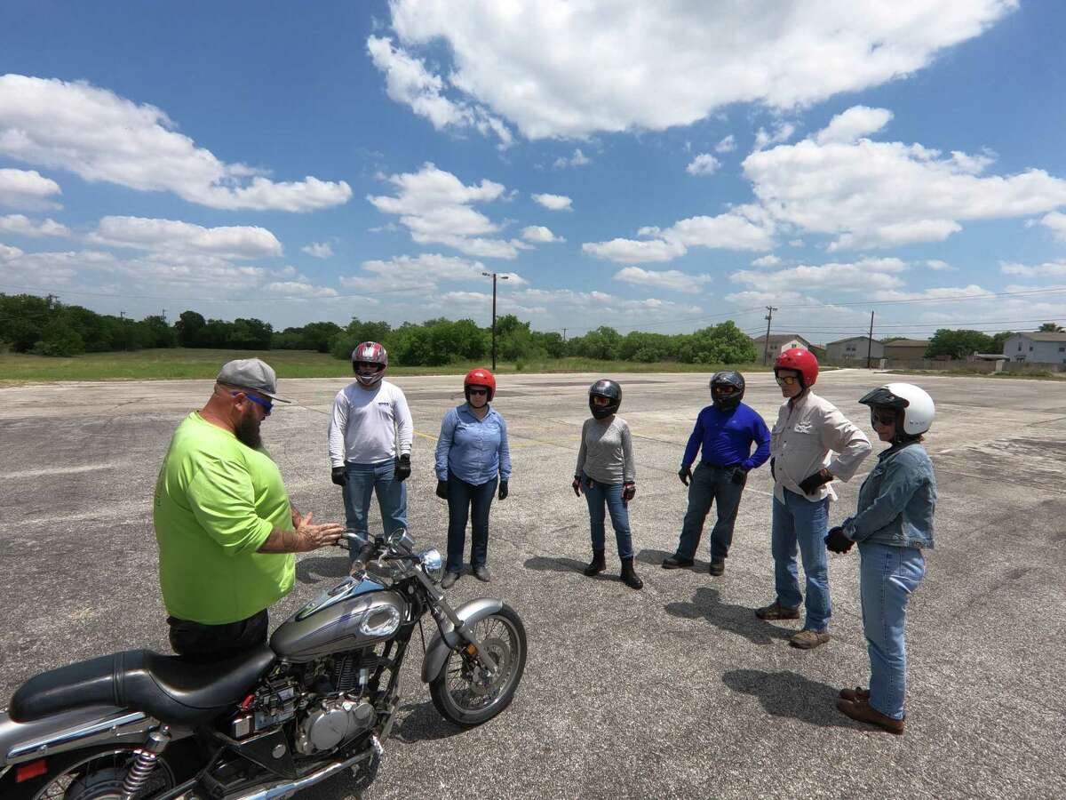 Ian Munce (left), of Southwest Motorcycle Training, works with novice riders earlier this month.