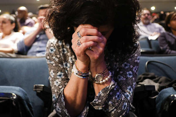 Vickie McGinty bows her head in prayer as she attends a Wednesday service at Lakewood Church.