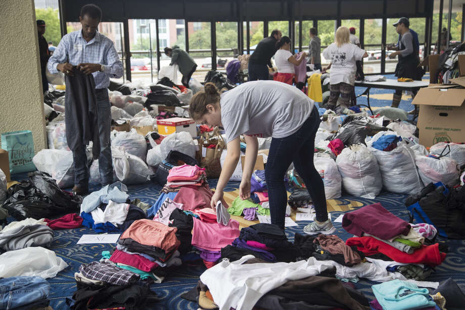 Volunteers sort through donations delivered to Lakewood Church. After the storm, the church sheltered Hurricane Harvey evacuees. Photo: Marie D. De Jesús