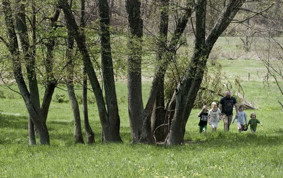 Families explore the property at Smyrski Farm in New Milford. Photo: Scott Mullin / For Hearst Connecticut Media / The News-Times Freelance