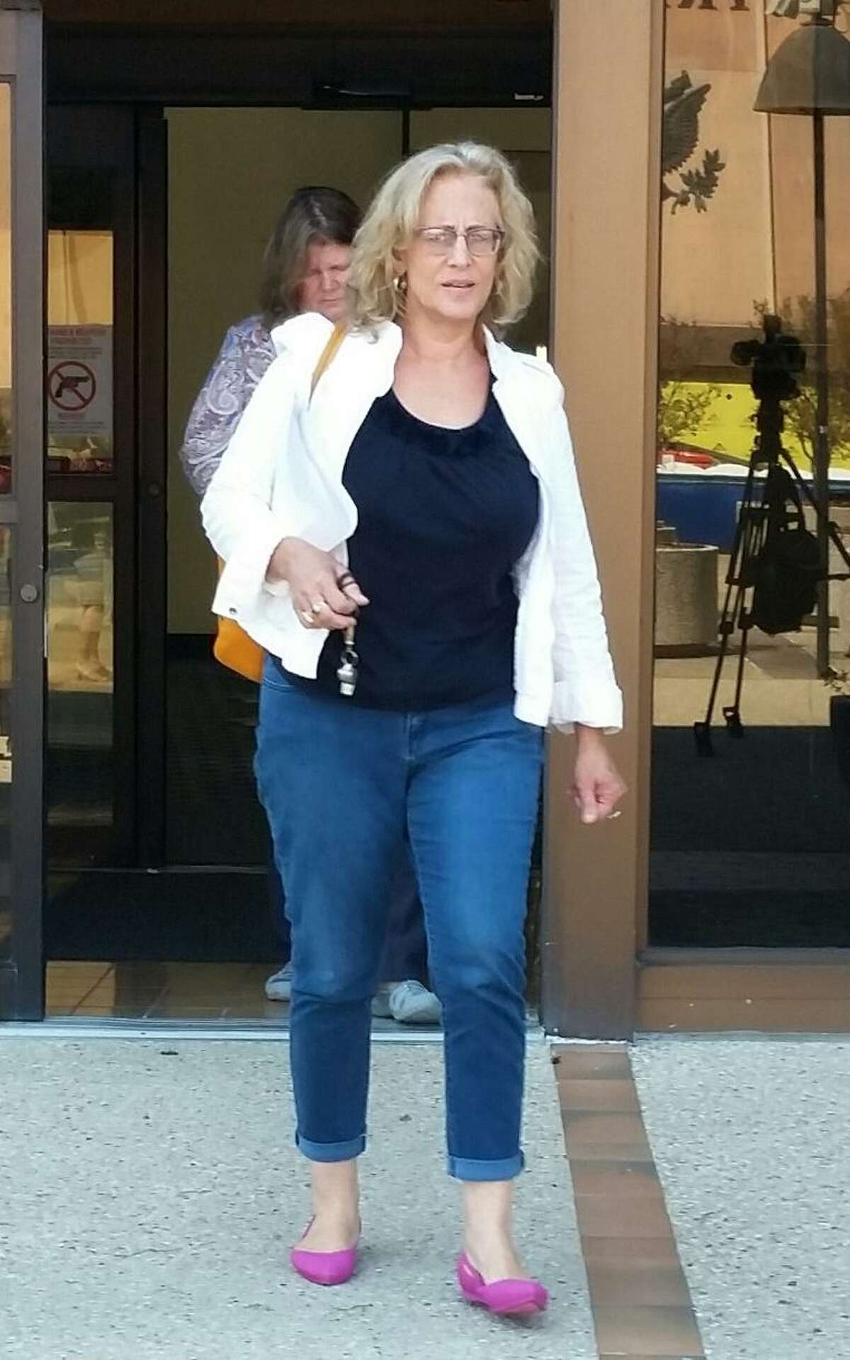 Jodi Mann, who describes herself as "Conspiracy Granny," leaves San Antonio's federal courthouse on Tuesday, May, 29, 2018, after her boyfriend, Robert Mikell Ussery, was denied bail. Ussery was arrested on a gun charge in the aftermath of the pair's confrontation in March with the pastor of the First Baptist Church of Sutherland Springs. Ussery and Mann claim the November massacre, in which 26 churchgoers were killed by a gunman, is a "government hoax."