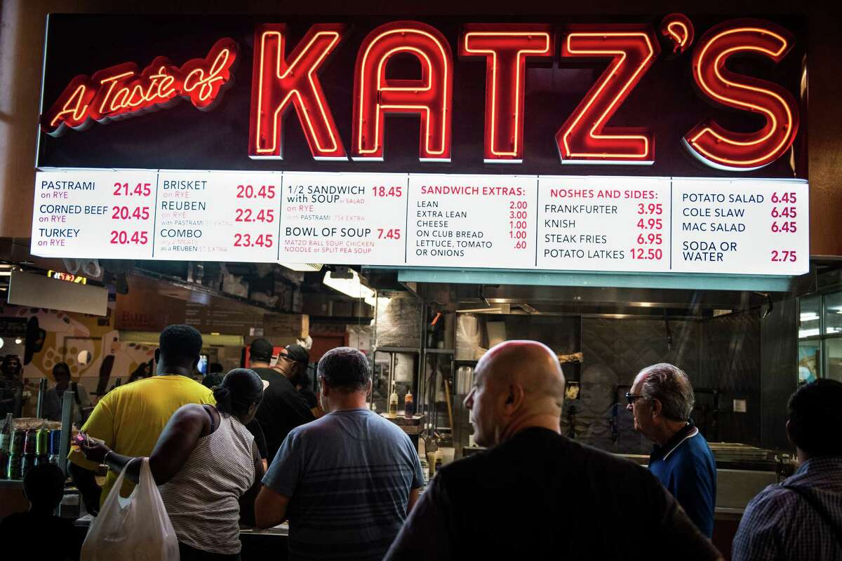 Customers wait in line to order from A Taste of Katz's deli inside DeKalb Market Hall at City Point in the Brooklyn borough of New York on July 18, 2017.