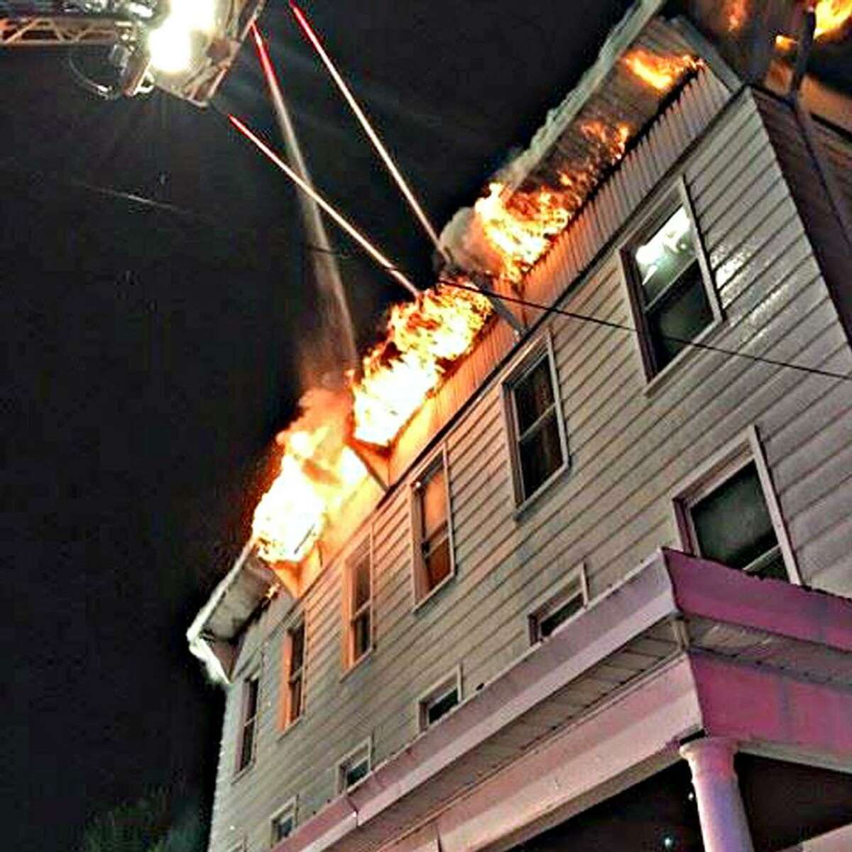 The blaze originated on a second-floor porch at the back, where an individual was grilling. There were no injuries in the fire, which began just before 10:45 p.m., the fire chief said.