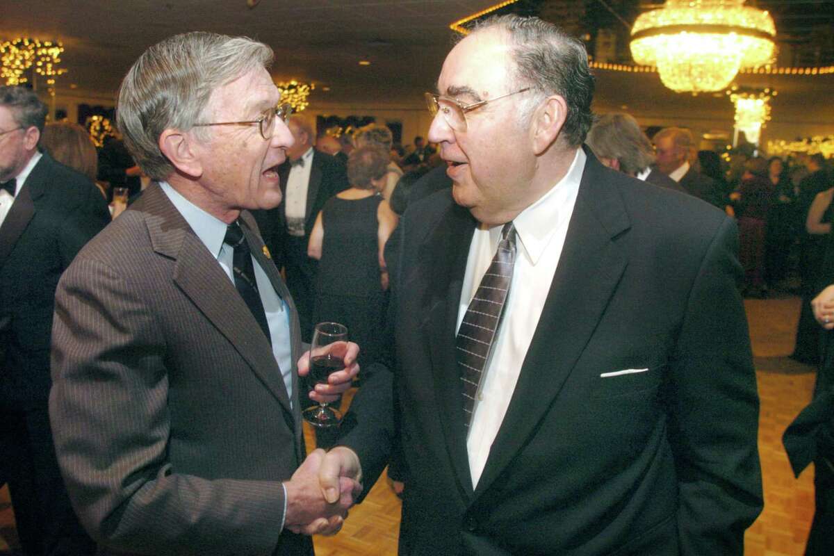 Norwalk_012006_Mayor's Ball: Two former Democratic Mayors, who show that the Mayor's Ball is a truly bi-partisan event in Norwalk, (L) William Collins and Frank Zullo shake hands and do a little governmental reminiscence. by Paul Desmarais/ Staff Photo: METRO