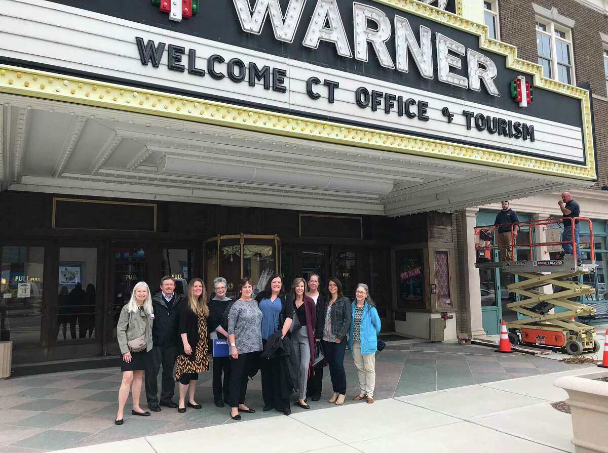 Connecticut Tourism Office representatives gather under the Warner’s marquis during their recent visit to Torrington.