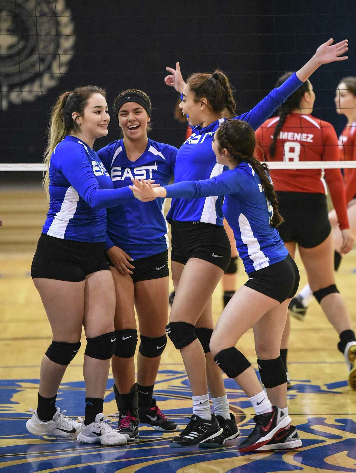 The East team celebrates after scoring a point during the Bosom Buddies All-Star game at St. Augustine. The East won with a 3-0 (25-6, 25-12, 26-24) sweep.
