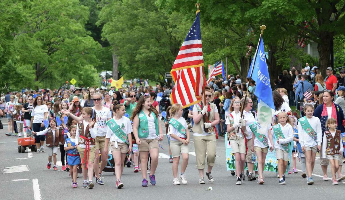 Numerous community organizations participated in the New Milford Memorial Day parade May 28, 2018. Above, Girl Scouts make their way along the east side of the Green at the start of the parade.