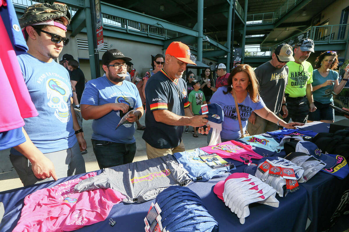 Jerry Barrazo (from left), Jorge Lozano, Ruben Hernandez and Diane Hernandez look over Flying Chanclas shirts and caps during the Flying Chanclas' game with Tulsa at Wolff Stadium on Thursday, May 24, 2018. MARVIN PFEIFFER/mpfeiffer@express-news.net