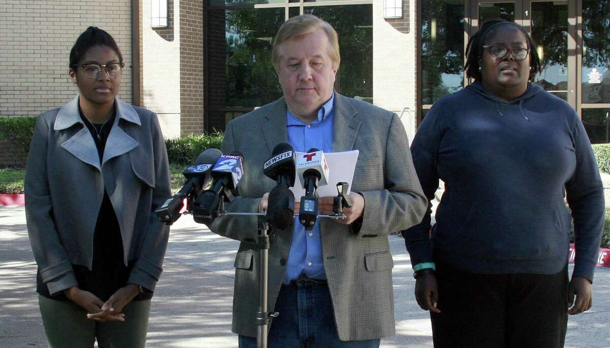 LaShan Arcenaux, right, filed a federal lawsuit on behalf of her daughter M.O. left, a student at Klein Oak High School, for alleged bullying by officials because she didn't stand during the Pledge of Allegiance. At a press conference on Oct. 25 her lawyer, Randall Kallinen, center, said that officials making M.O. stand for the pledge violates her freedom of speech.