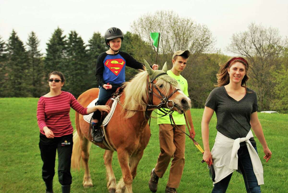 Little Britches therapeutic riding will hold its annual fundraiser on June 17. Above, volunteers lead a young rider and horse during last year’s event.