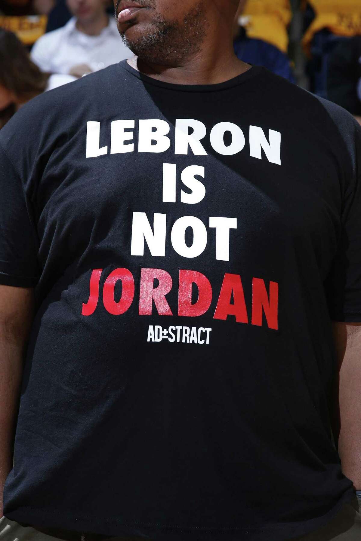 CINCINNATI, OH - OCTOBER 7: A fan displays a shirt comparing LeBron James #23 of the Cleveland Cavaliers to former NBA great Michael Jordan before a preseason game against the Atlanta Hawks at Cintas Center on October 7, 2015 in Cincinnati, Ohio. The Hawks defeated the Cavaliers 98-96. NOTE TO USER: User expressly acknowledges and agrees that, by downloading and or using the photograph, User is consenting to the terms and conditions of the Getty Images License Agreement. (Photo by Joe Robbins/Getty Images)