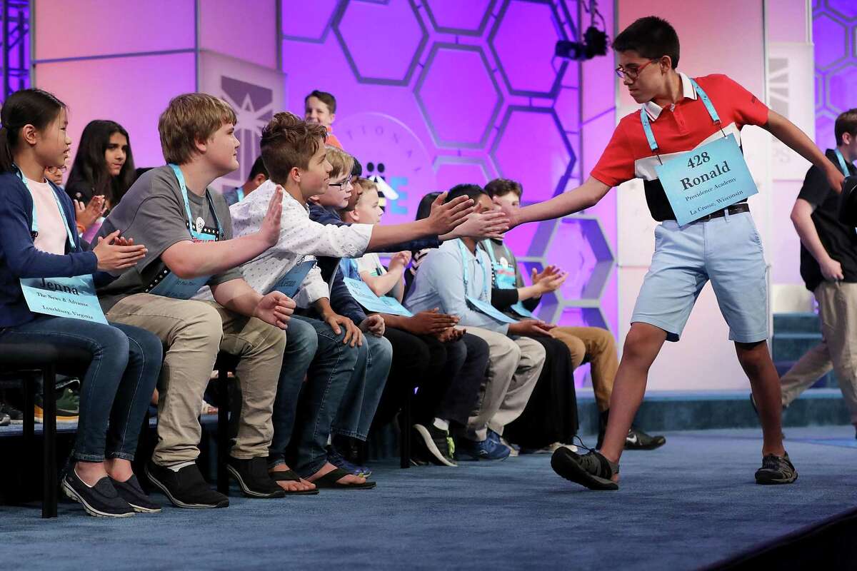 NATIONAL HARBOR, MD - MAY 30: Despite misspelling his word, Ronald Walters of Onalaska, Wisconsin, is high-fived by his fellow competitors during the third round of the 91st Scripps National Spelling Bee at the Gaylord National Resort and Convention Center May 31, 2018 in National Harbor, Maryland. 516 spellers from across the country and around the world competed in the bee. (Photo by Chip Somodevilla/Getty Images)